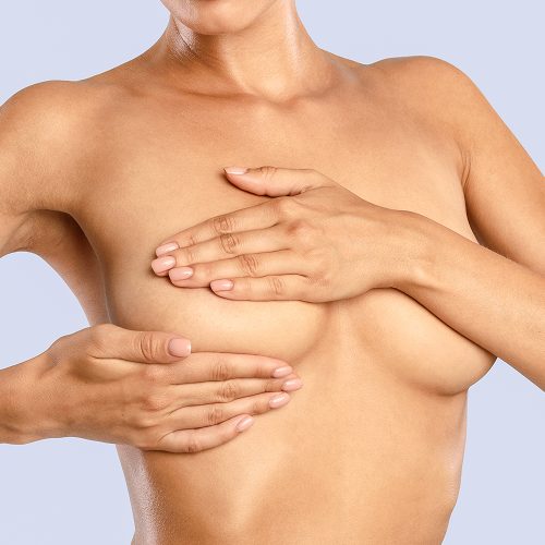 Woman covering her chest during a breast examination