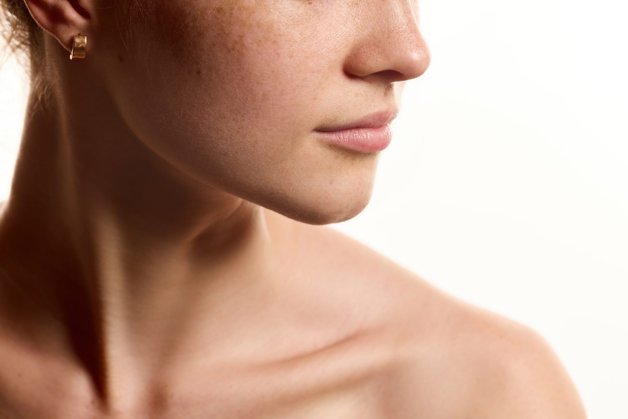 Close-up of a woman’s jawline and neck.